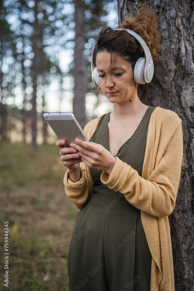 one woman in park or forest online guided meditation self-care concept one woman in park or forest online guided meditation self-care concept