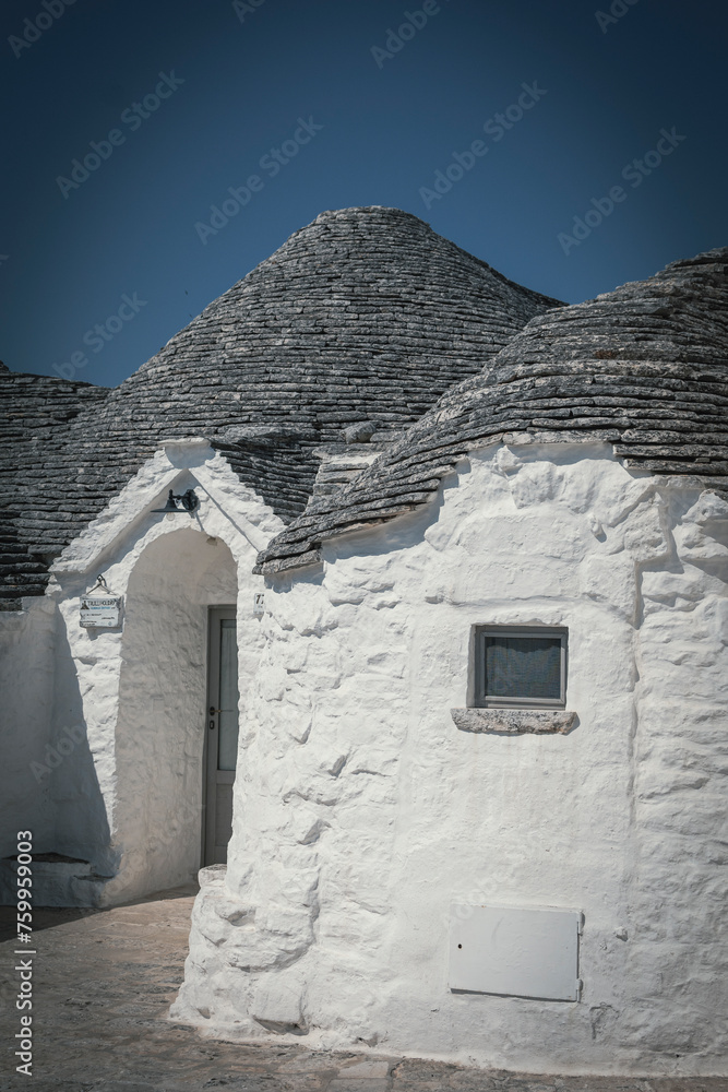 The typical Trulli of Alberobello. Medieval white stone houses created to protect from the heat of the southern italy summer.