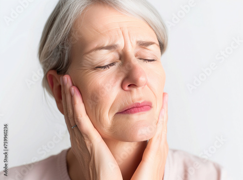 mature woman holding her face