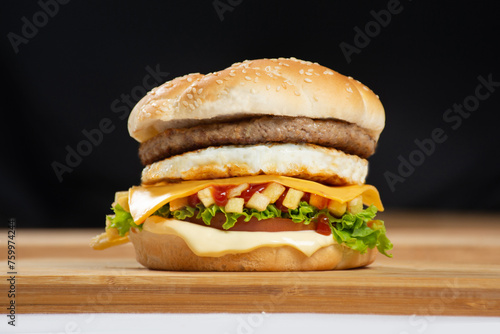 Close-up of beef burger on white background. Hamburger - bun, grilled meat burger, lettuce, tomato and fried egg.