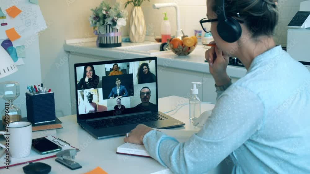 Videocall, remote online meeting during covid-19 lockdown. A lady is participating on an online meeting from home Videocall, remote online meeting during covid-19 lockdown. A lady is participating on an online meeting from home