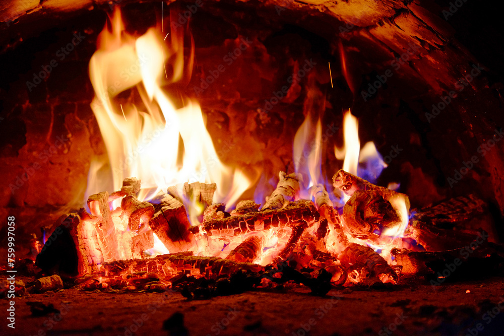 A dynamic display of flames engulfs the wood in a fiery dance.