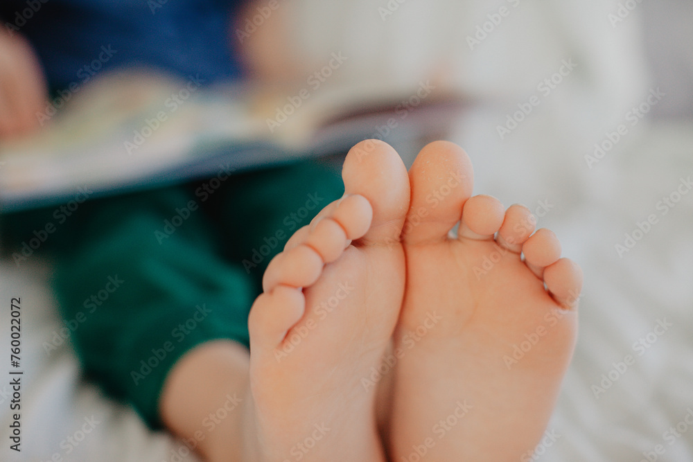 Boy is reading in the bedroom on the bed Boy is reading in the bedroom on the bed