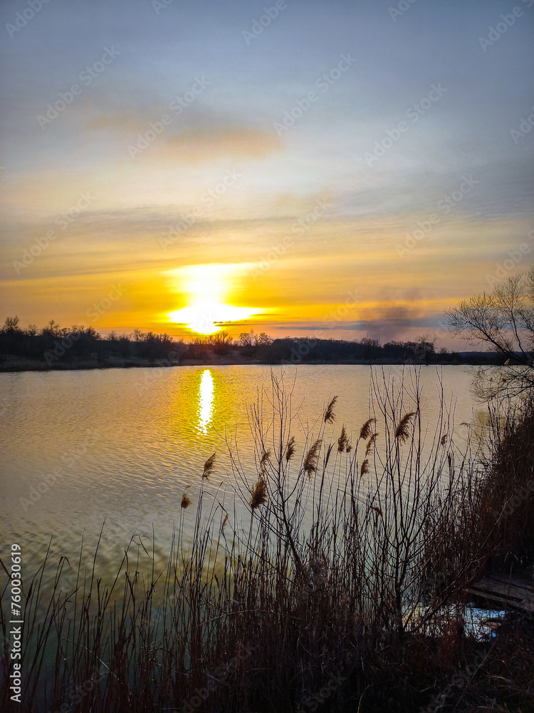 Sunset over the river and red sun . Trees on beach . Reflactions on water. Grass and trees . Red sunset . Sun and forest Sunset over the river and red sun . Trees on beach . Reflactions on water. Grass and trees . Red sunset . Sun and forest