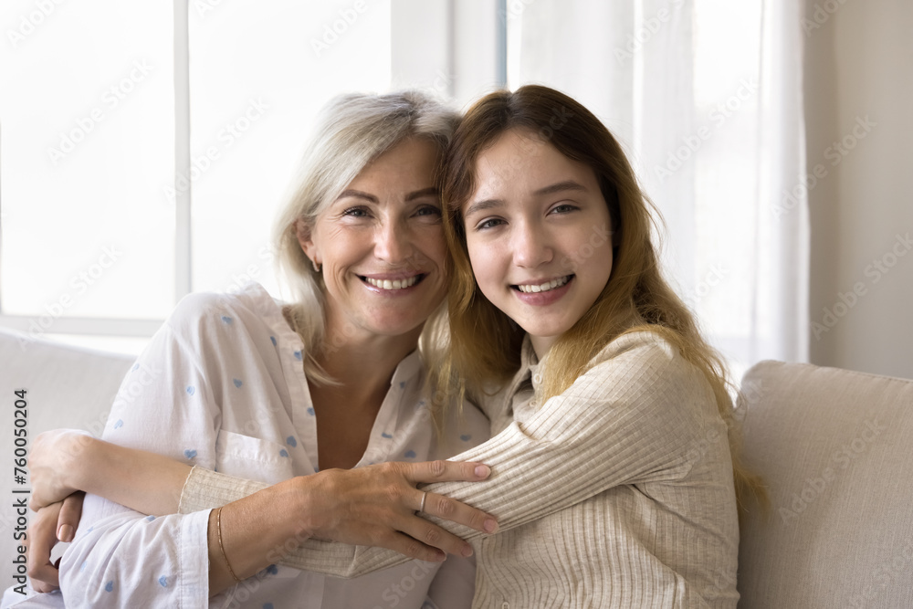 Portrait of mature mom and pre-teen daughter looking at cam. Familial love, support, understanding between teenager and mother, unwavering affection, genuine friendship, profound sense of connection Portrait of mature mom and pre-teen daughter looking at cam. Familial love, support, understanding between teenager and mother, unwavering affection, genuine friendship, profound sense of connection