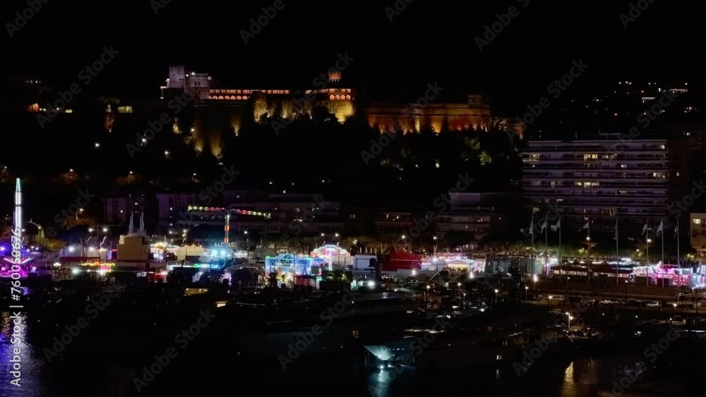 Monaco, Monte-Carlo, Bright festive carousel operating at the Christmas festivities at night, vibrant color, night illumination, clouds over port Hercules Monaco, Monte-Carlo, Bright festive carousel operating at the Christmas festivities at night, vibrant color, night illumination, clouds over port Hercules