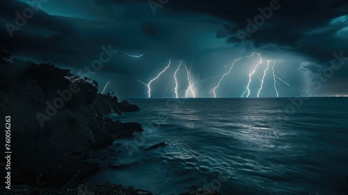 Multiple lightning bolts strike the ocean at night  viewed from a high coastal cliff