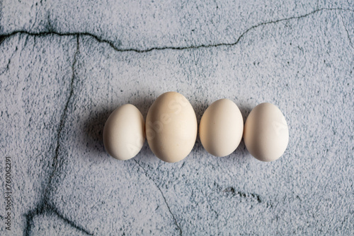 Four white eggs on an empty background. Easter concept