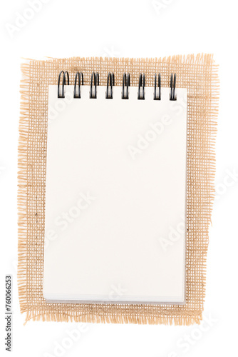 Notepad on jute, burlap. Notepad on white background - top view. 