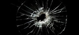 Bullet hole in glass isolated on black