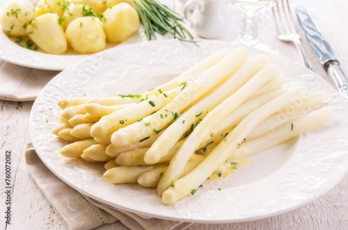 Traditional German white  asparagus with boiled potatoes served as close-up on a classic design plate