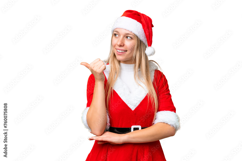 Young blonde woman with christmas hat over isolated chroma key background pointing to the side to present a product Young blonde woman with christmas hat over isolated chroma key background pointing to the side to present a product