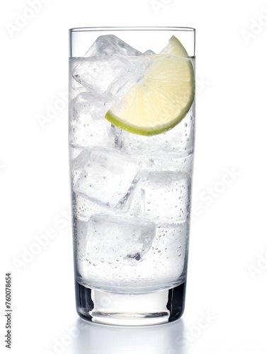 A tall glass of gin tonic with ice cubes and a lime wedge