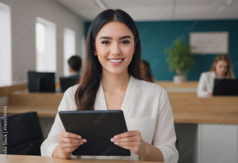 Woman in office with a tablet, professional poise. Confident stance and engaging smile. Woman in office with a tablet, professional poise. Confident stance and engaging smile.