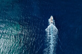 Vacation and leisure. Aerial view on fast boat on blue sea at sunny day. Fast ship on the sea surface. Seascape from the drone. Seascape from air. Seascape with motorboat.