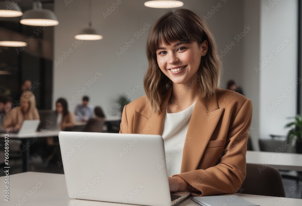 Young woman in beige jacket concentrating on laptop. Professional and dedicated business atmosphere. Young woman in beige jacket concentrating on laptop. Professional and dedicated business atmosphere.