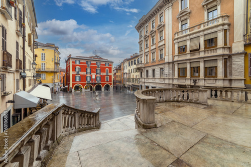 Mondovi, Italy: St. Peter's Square, view of the historic buildings decorated with arcades and the square paved with stone slabs after rainy day
