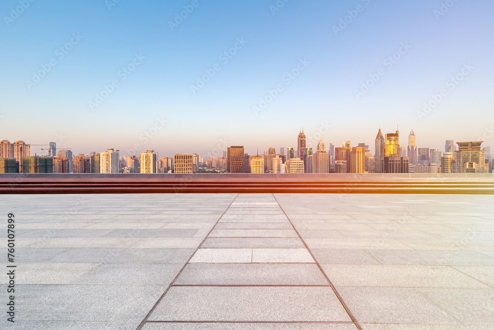 empty floor with skyline and buildings in sunrise