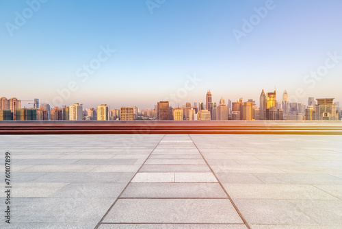 empty floor with skyline and buildings in sunrise (ID: 760107899)