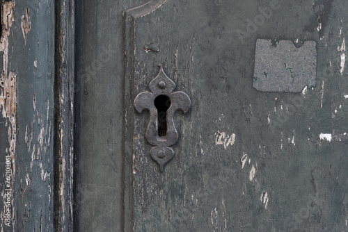 Keyhole metal on an old dark shabby vintage european door in the ancient city, vintage style, antique