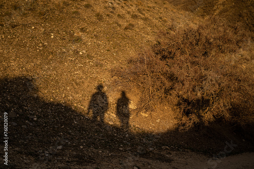 Two Shadows on Golden Hour Mountain Cliff