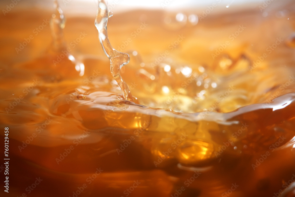 Close up of pouring golden liquid Close up of pouring golden liquid