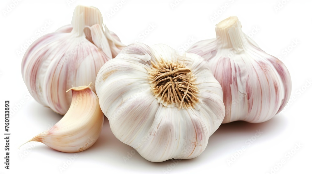 Image featuring fresh whole garlic bulbs and an individual garlic clove set against a white background Image featuring fresh whole garlic bulbs and an individual garlic clove set against a white background