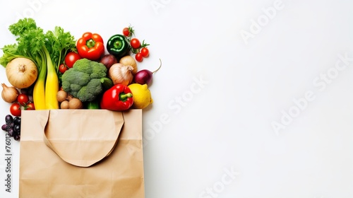 Assorted vegetables bursting out of a paper bag on a white backdrop, showcasing a variety of colors and shapes