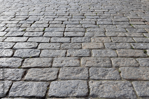 Obraz na płótnie City square street lined with square gray bricks, cobblestones, city pavement all over the square to the horizon - close-up, blurred background w salonie