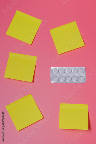 Obraz na płótnie A pack of pills and a few yellow notes on a pink background - healthcare, scheduled medications, therapy, contraception, timetable, vertical view w salonie