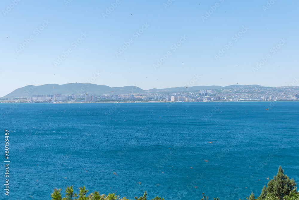 Sea horizontal landscape - blue sky, blue sea, mountain hills on the horizon