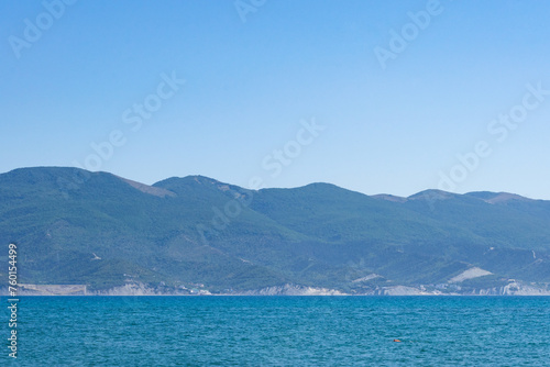 Obraz na płótnie Sea horizontal landscape - blue sky, blue sea, mountain hills on the horizon w salonie