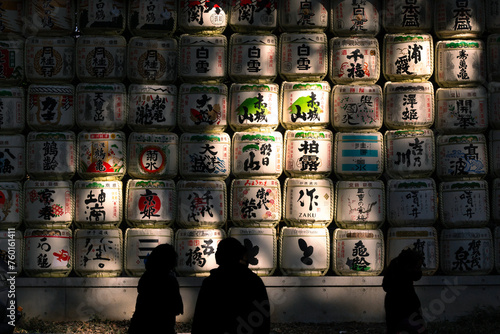 Tourists look at Meiju Jungu Traditional Japanese Sake Barrels in Harajuku, Tokyo Japan