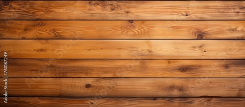 A closeup shot of a hardwood brown plank wooden wall with a blurred amber background  showcasing the beautiful wood grain and natural wood stain