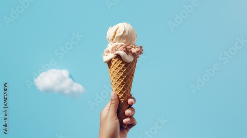 A hand presents a mouthwatering cone of ice cream juxtaposed with a fluffy cloud in the sky