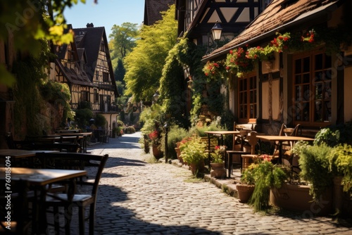 Cobblestone street lined with tables and chairs in charming small town