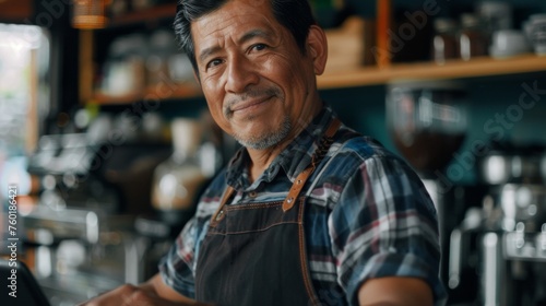 Portrait of a happy coffee shop worker with a tablet