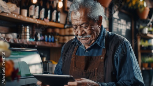 Portrait of a happy coffee shop worker with a tablet