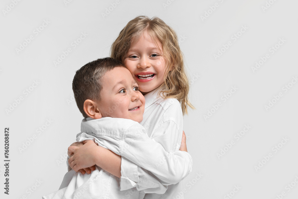 Cute little children hugging on white background. Happy family Cute little children hugging on white background. Happy family
