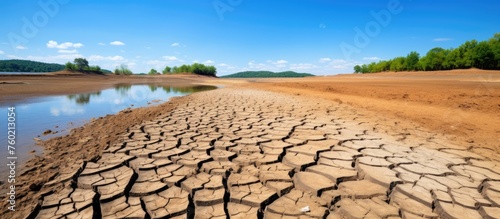 Barren Desert Landscape with Dry River Bed under Scorching Sunlight