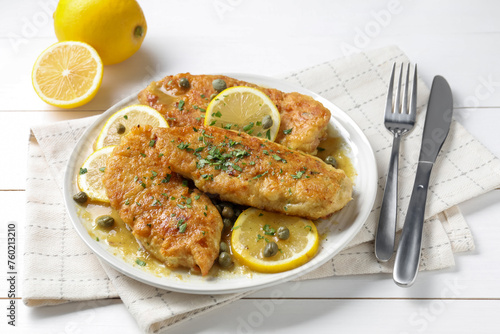 Delicious chicken piccata served on white table