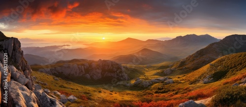 Majestic Mountain Range Silhouetted By Vibrant Sunset Sky Over Scenic Landscape