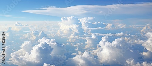 Awe-Inspiring Aerial View of Scattered Clouds and Sunlight from Inside Airplane Window photo