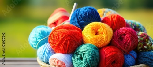 Vibrant Basket of Colorful Yarns Arranged on a Rustic Wooden Table in a Cozy Knitting Scene