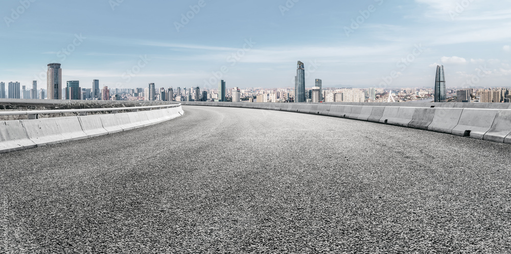 Empty Urban Road with City Skyline Under Clear Sky