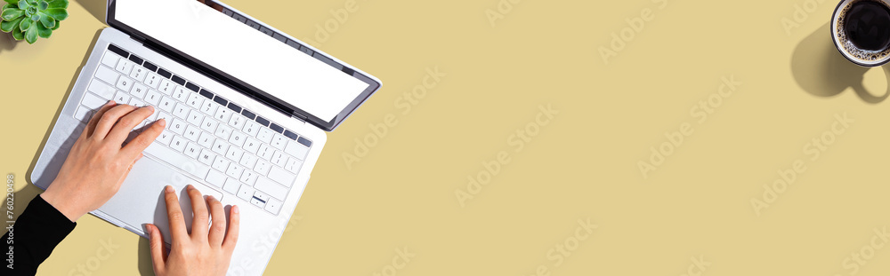 Person using a laptop computer from above Person using a laptop computer from above