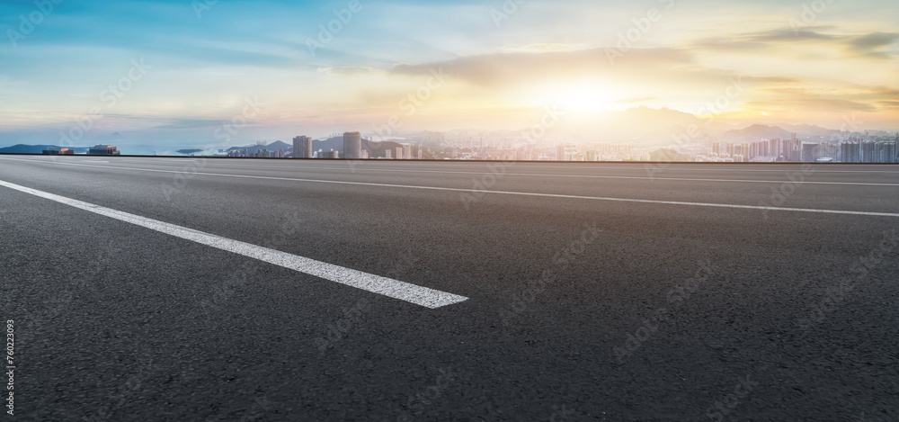 Sunrise on Horizon Behind Urban Skyline from Road Sunrise on Horizon Behind Urban Skyline from Road