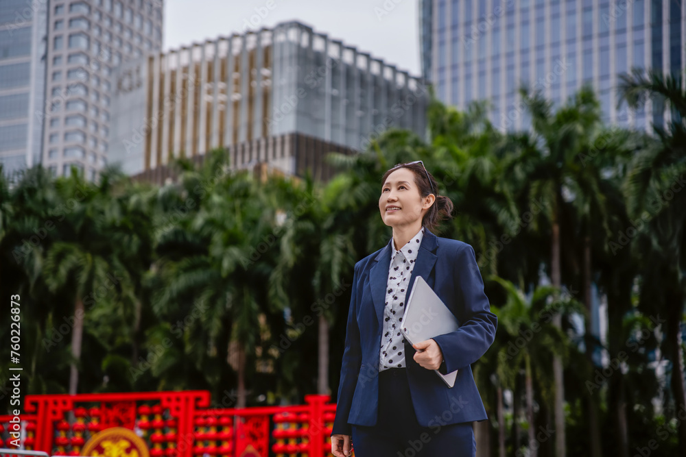Confident Businesswoman Walking in a City Environment Confident Businesswoman Walking in a City Environment