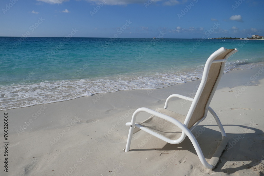 Tranquil scene with beach chair and clear ocean in background Tranquil scene with beach chair and clear ocean in background