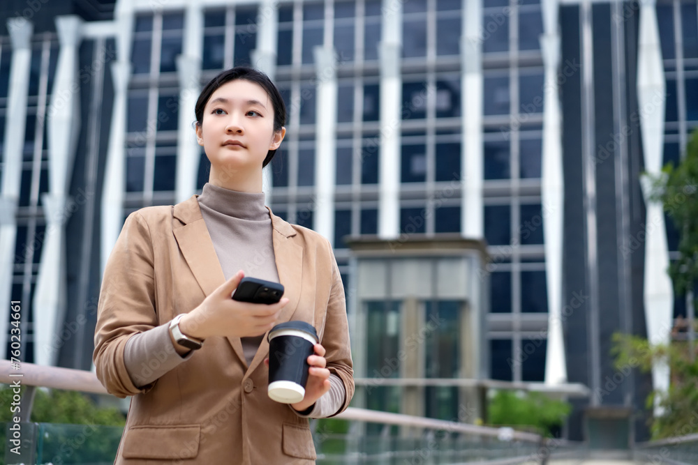 Young Professional Woman Using Smartphone Outdoors